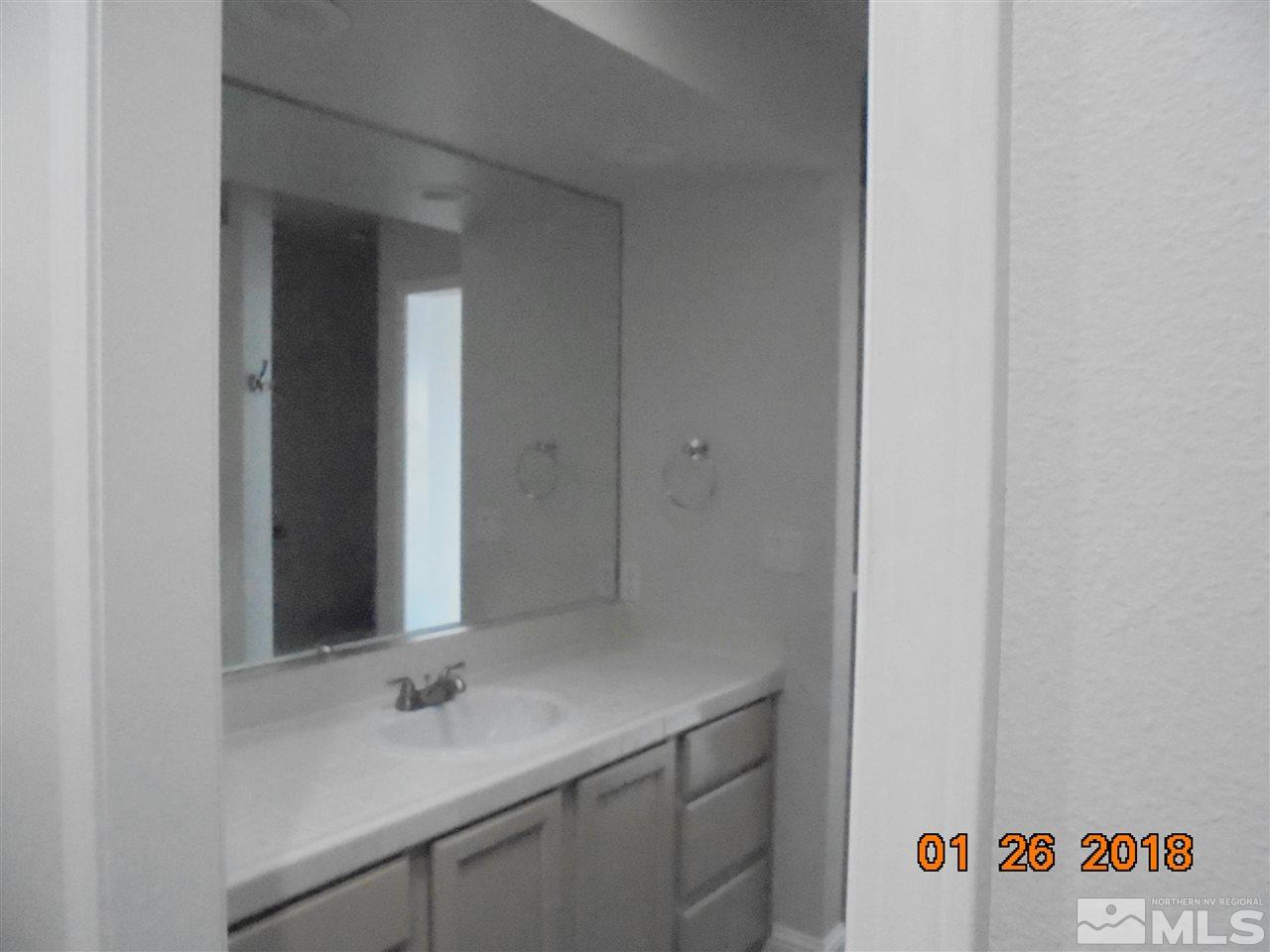 3635 Skyline Boulevard Reno, NV 89509 - Photo 23 of 37 a bathroom with a sink and a mirror
