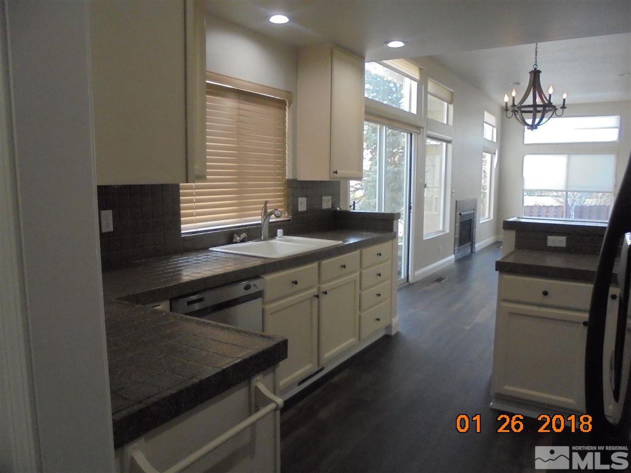 3635 Skyline Boulevard Reno, NV 89509 - Photo 31 of 37 a kitchen with stainless steel appliances granite countertop a sink stove and cabinets