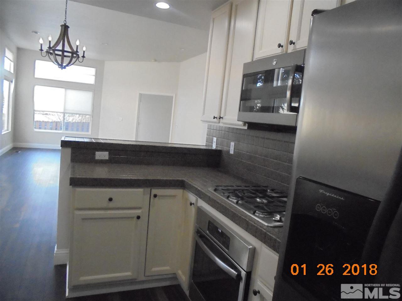 3635 Skyline Boulevard Reno, NV 89509 - Photo 33 of 37 a kitchen with stainless steel appliances a cabinets and a stove top oven