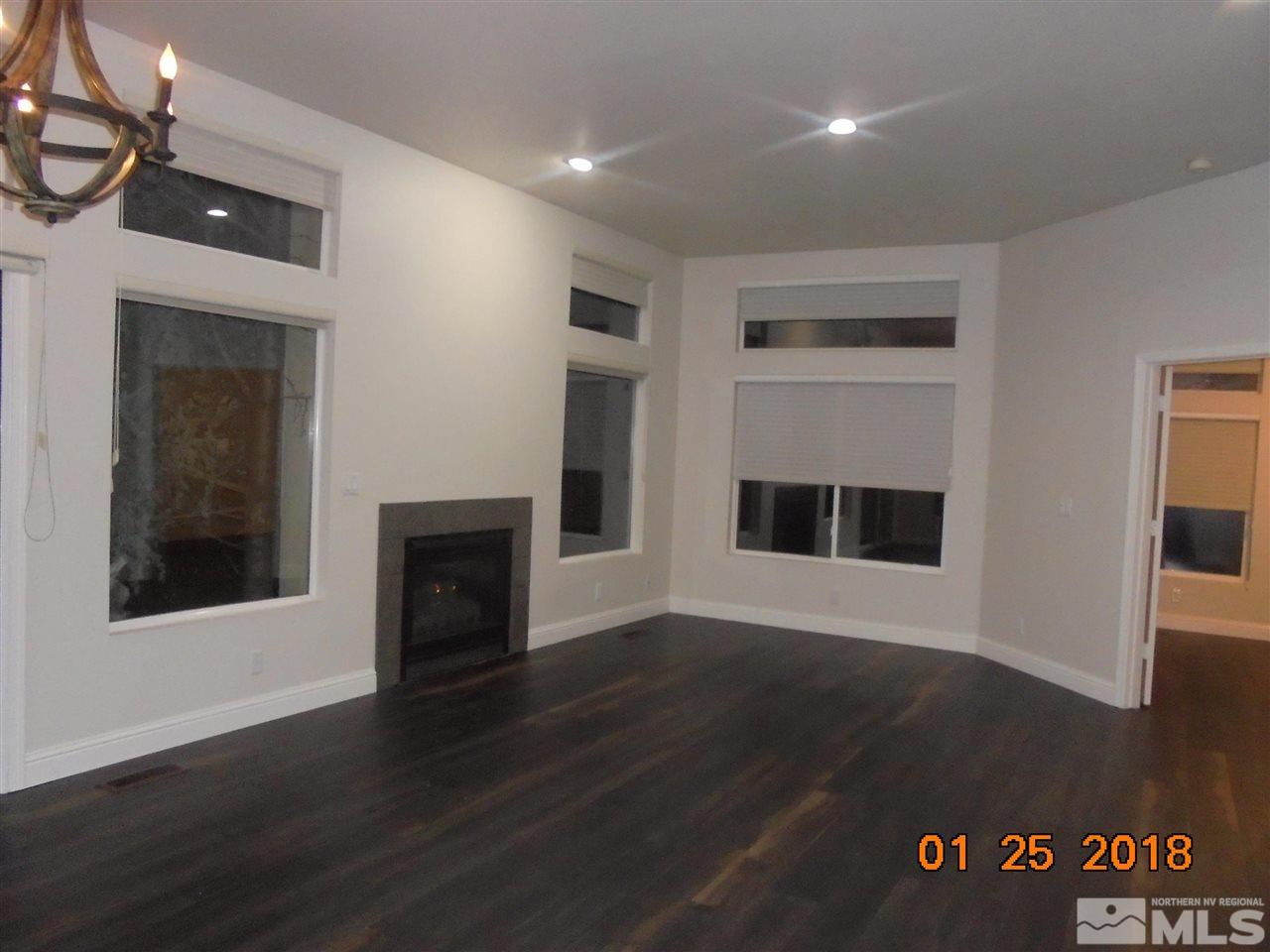 3635 Skyline Boulevard Reno, NV 89509 - Photo 5 of 37 a view of a livingroom with wooden floor and a fireplace