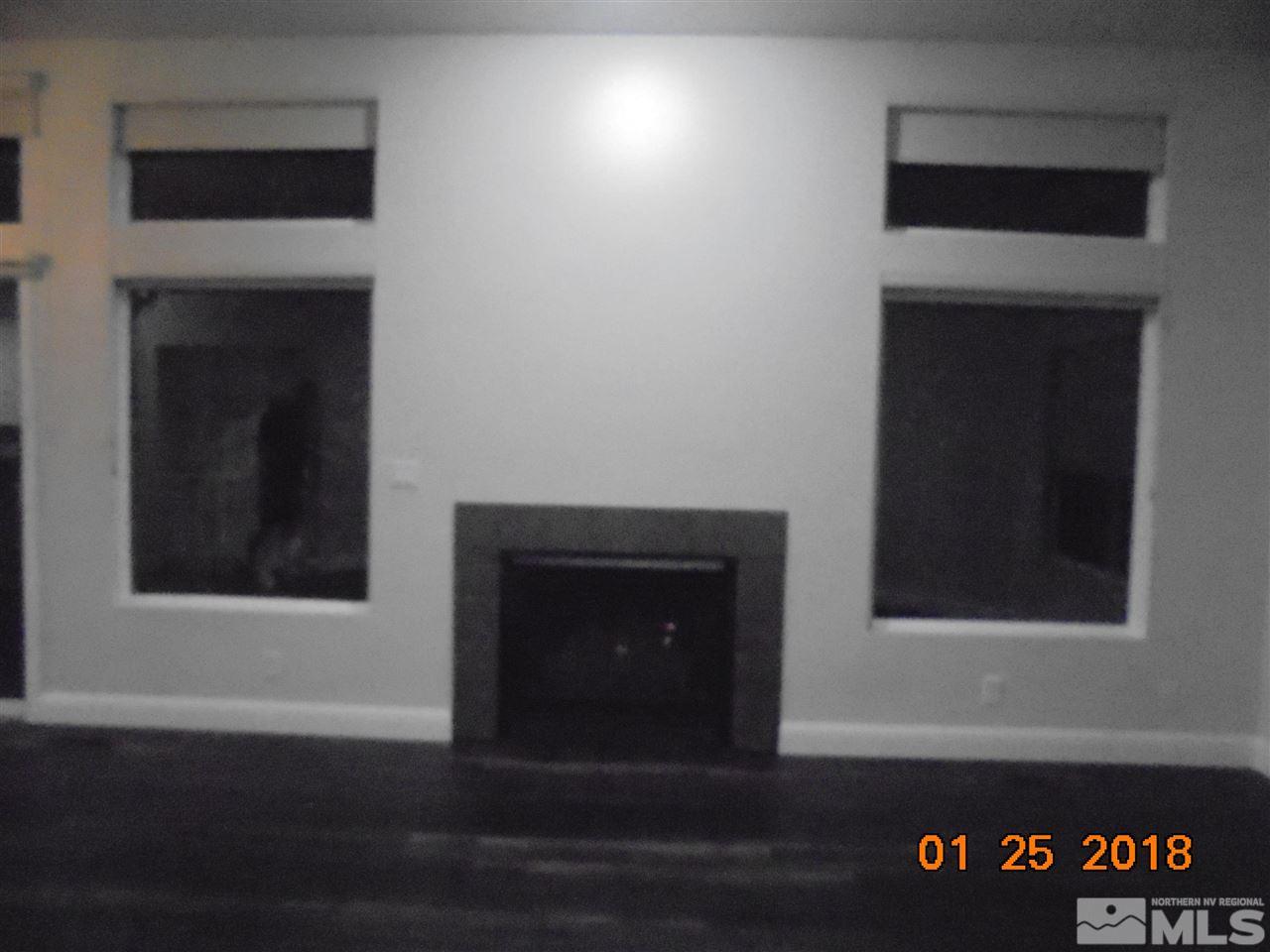 3635 Skyline Boulevard Reno, NV 89509 - Photo 6 of 37 a view of an empty room with wooden floor and a window