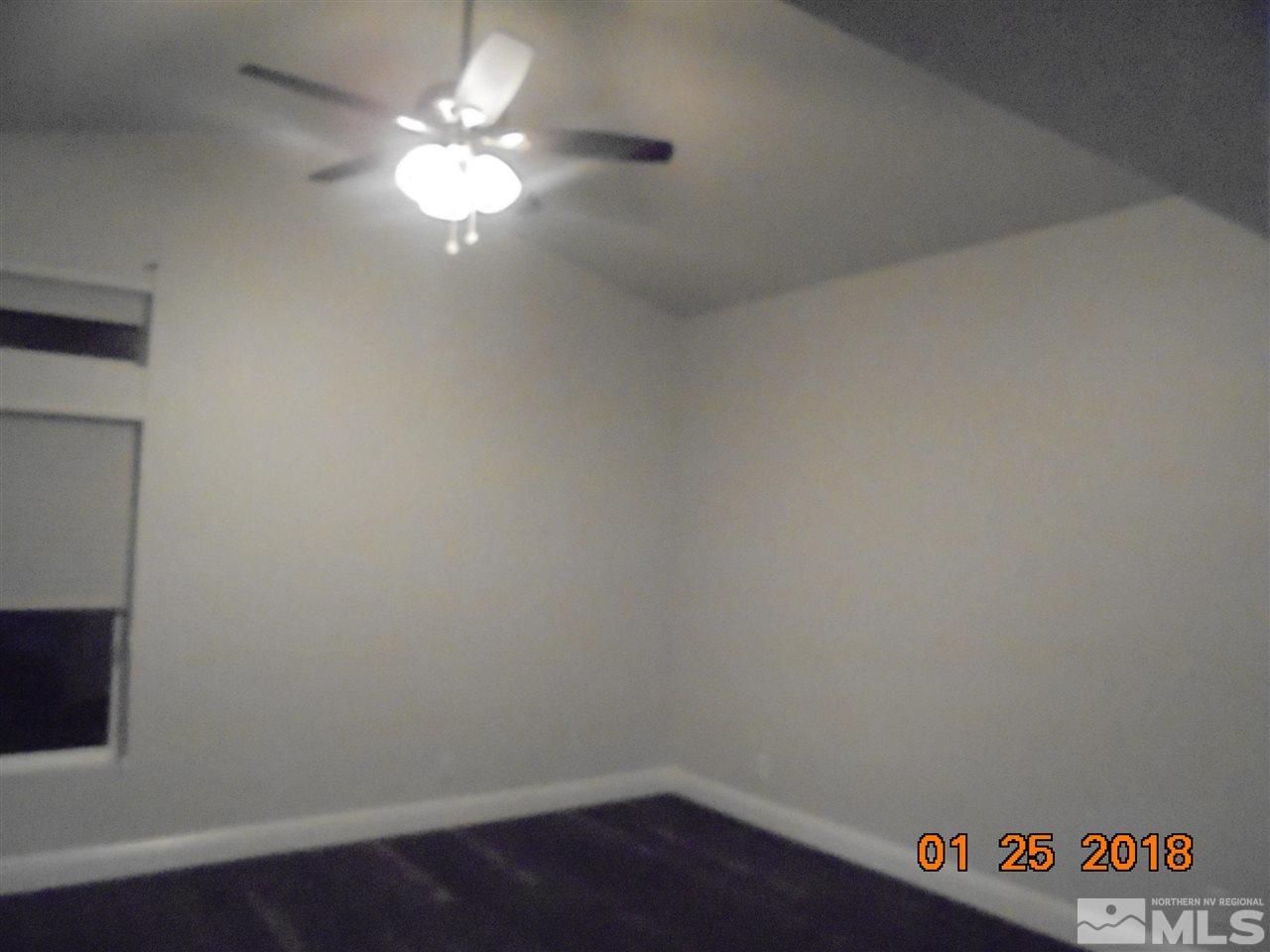 3635 Skyline Boulevard Reno, NV 89509 - Photo 7 of 37 a room with a chandelier fan and a table