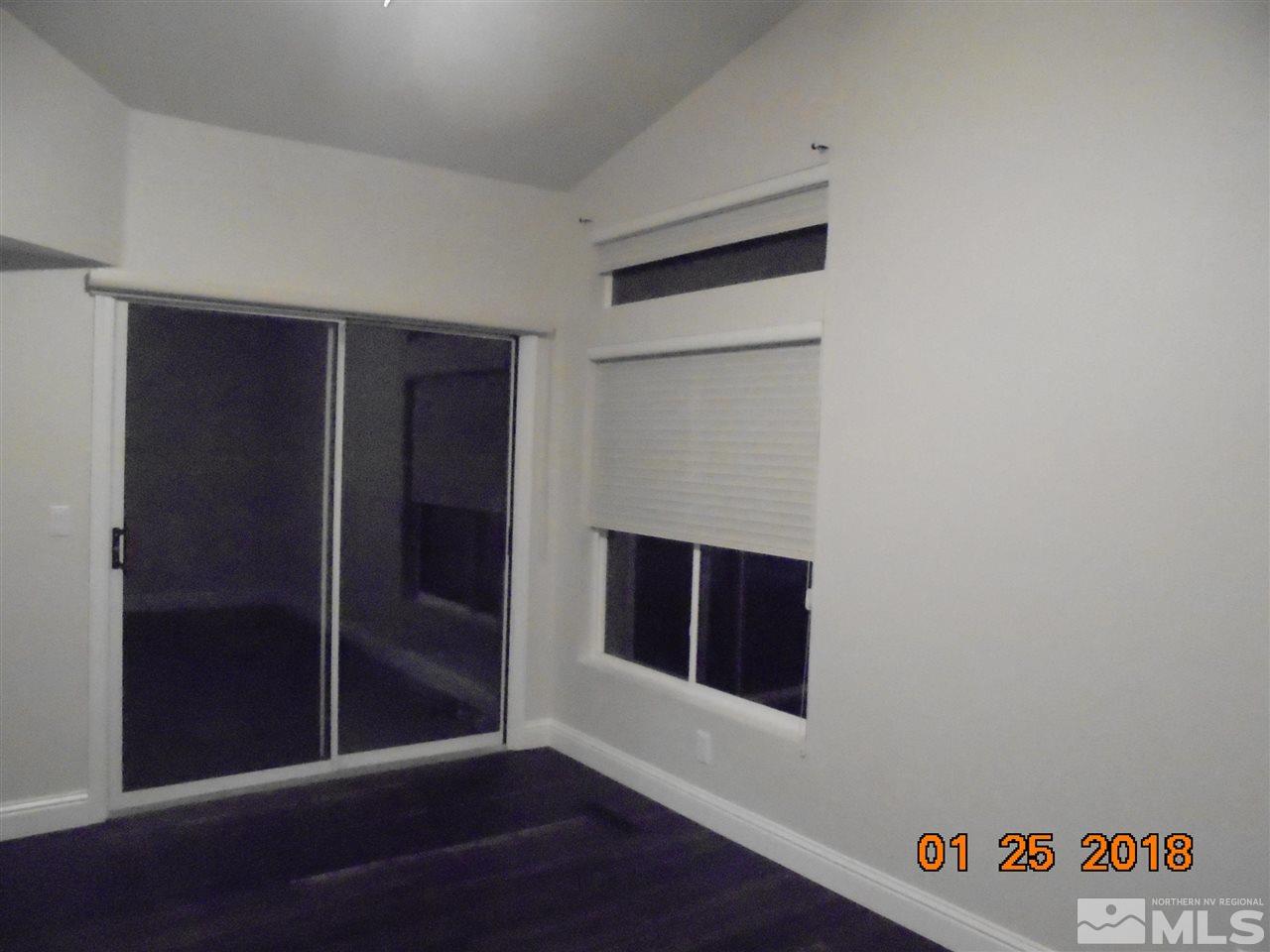 3635 Skyline Boulevard Reno, NV 89509 - Photo 8 of 37 a view of a hallway with wooden floor and a fireplace