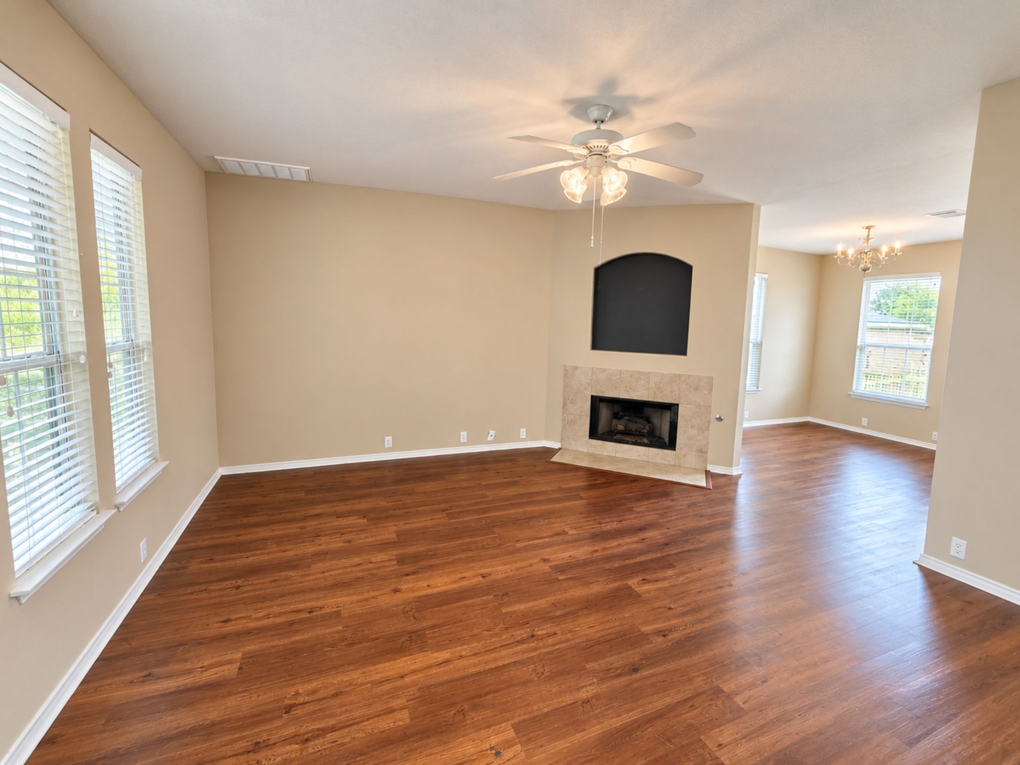 5679 Fergus, Unit B Kyle, TX 78640 - Photo 5 of 26 Rich wood flooring runs throughout this spacious, open-concept living area with a classic fireplace.