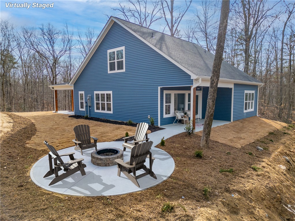 322 Oconee Avenue Westminster, SC 29693 - Photo 28 of 43 This newly constructed home boasts charming curb appeal and a serene outdoor fire pit area.