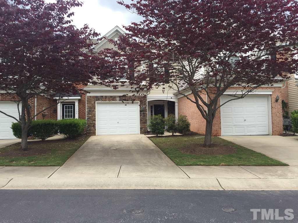 7137 Racine Way Raleigh, NC 27615 - Photo 1 of 13 a front view of a house with yard and parking