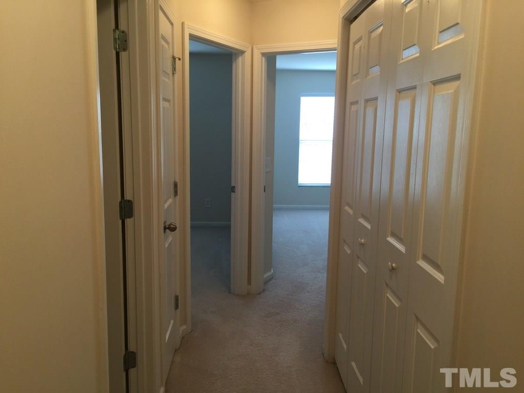 7137 Racine Way Raleigh, NC 27615 - Photo 11 of 13 a bathroom with a shower and a door
