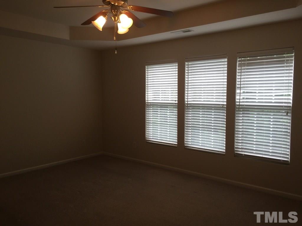 7137 Racine Way Raleigh, NC 27615 - Photo 7 of 13 a view of an empty room with a window