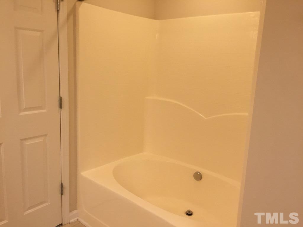 7137 Racine Way Raleigh, NC 27615 - Photo 8 of 13 a bathroom with a bathtub