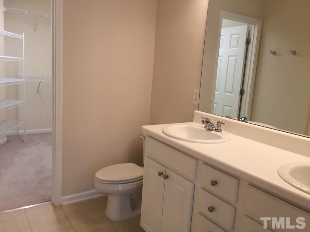 7137 Racine Way Raleigh, NC 27615 - Photo 9 of 13 a bathroom with a sink a toilet and a mirror
