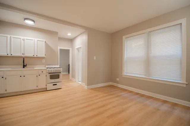 a view of kitchen with wooden floor and electronic appliances