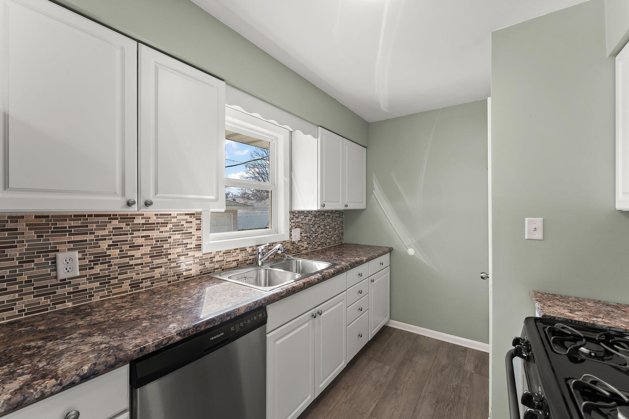947 North Wood Street Griffith, IN 46319 - Photo 9 of 25 a kitchen with granite countertop a sink and a stove
