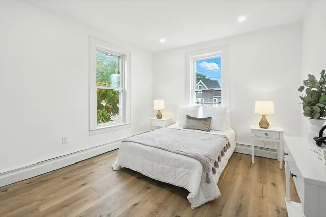 a bedroom with a bed and large window