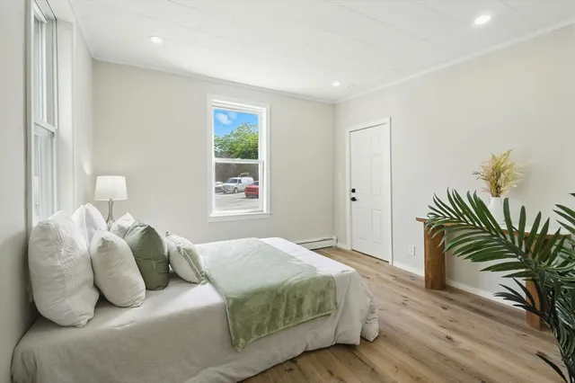a bedroom with bed and a potted plant