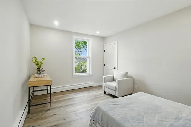 a bedroom with a bed and a chair