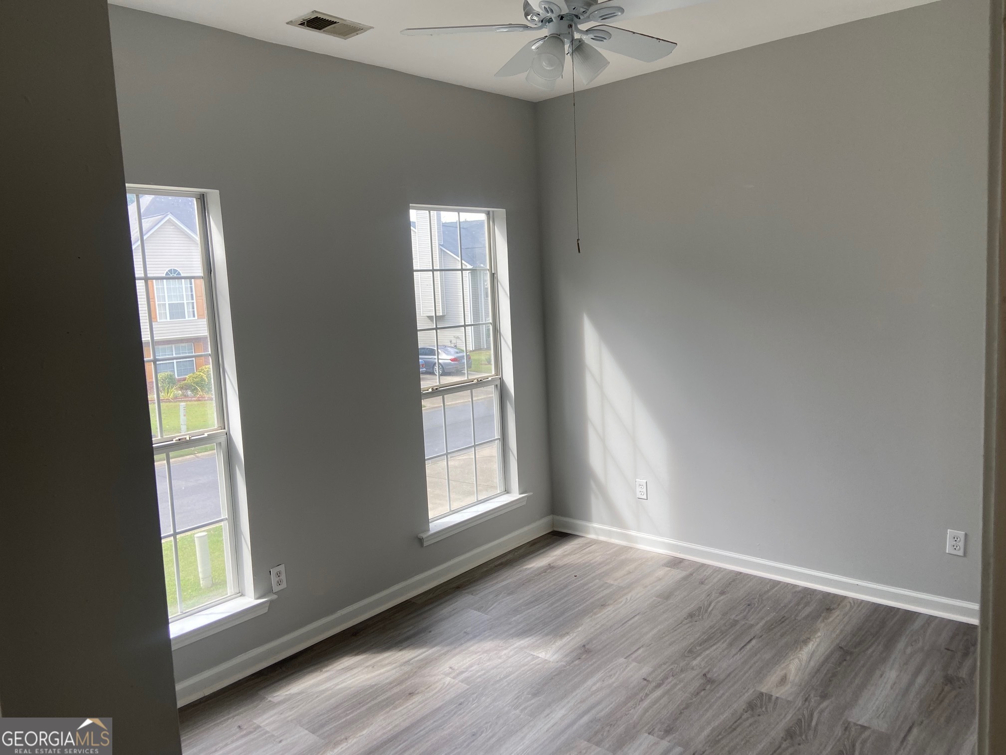 3536 Perry Pointe Austell, GA 30106 - Photo 22 of 32 an empty room with wooden floor and windows