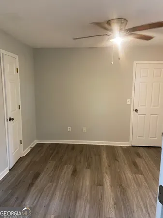 a view of an empty room and wooden floor