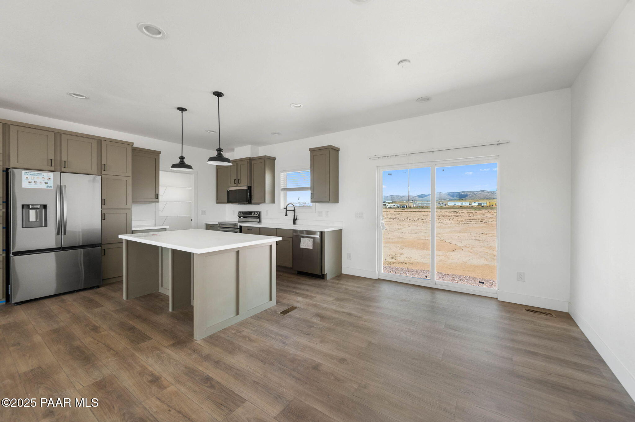 2688 West Altimeter Way Paulden, AZ 86334 - Photo 4 of 22 a large kitchen with a wooden floor and stainless steel appliances