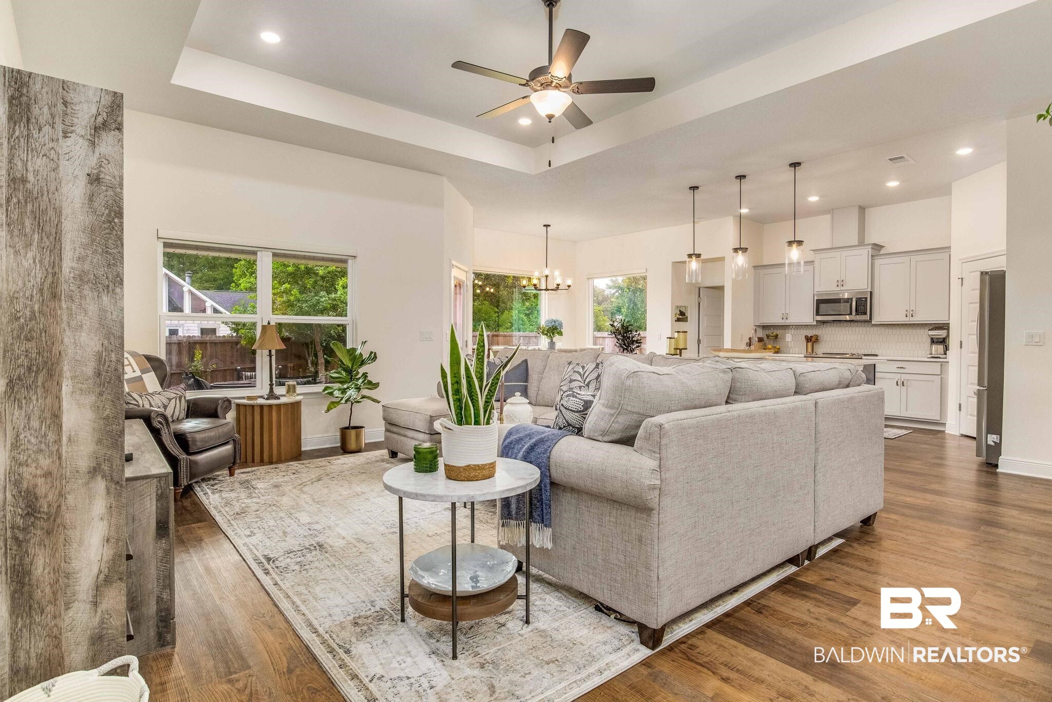 2222 Club House Drive Lillian, AL 36549 - Photo 9 of 49 Living room featuring recessed lighting, a raised ceiling, a chandelier, dark wood-style flooring, and ceiling fan
