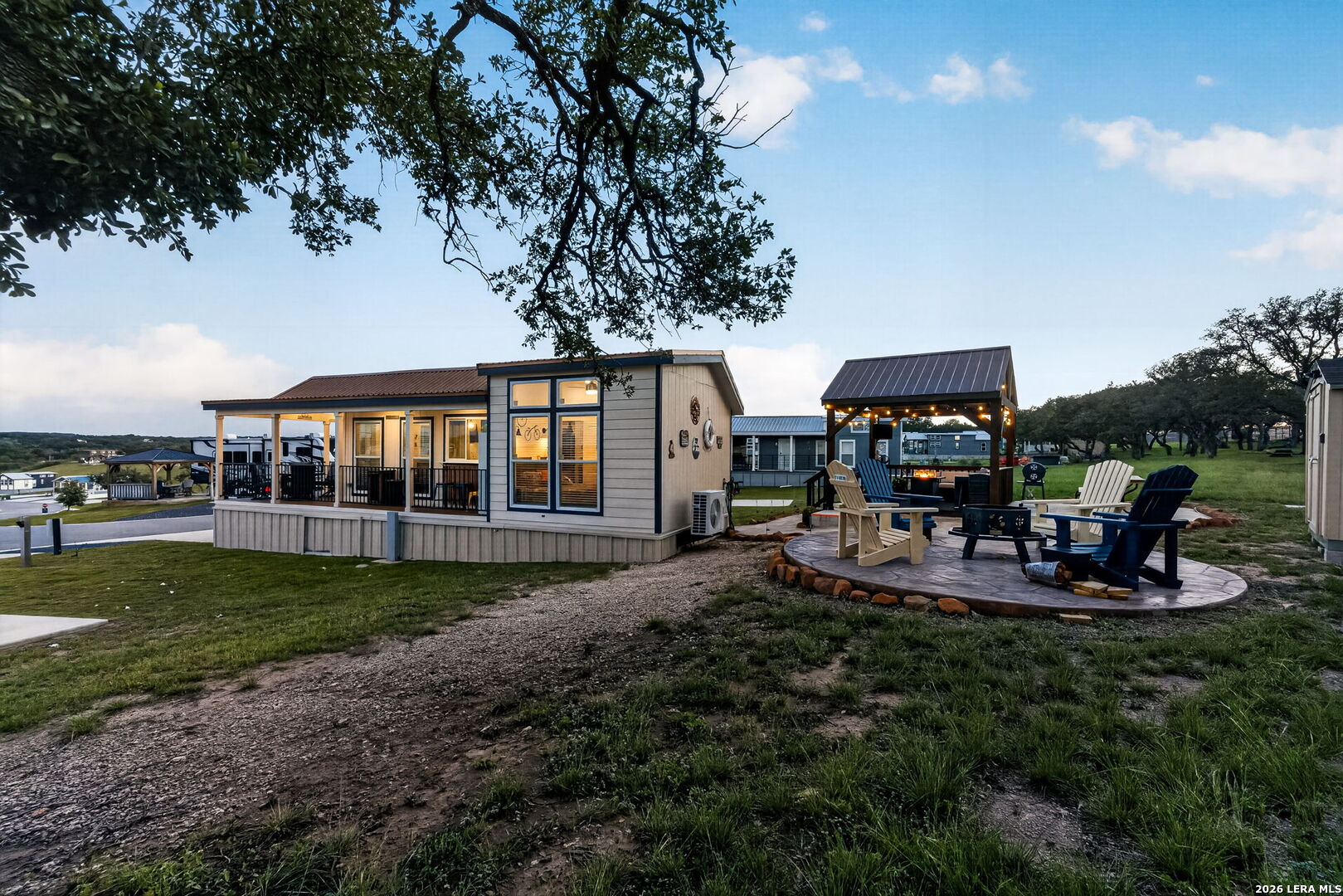 5386 Ranch Road 1376, Unit 64 Fredericksburg, TX 78624 - Photo 21 of 45 a view of a house with backyard porch and sitting area