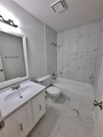 a bathroom with a double vanity sink toilet mirror and bathtub