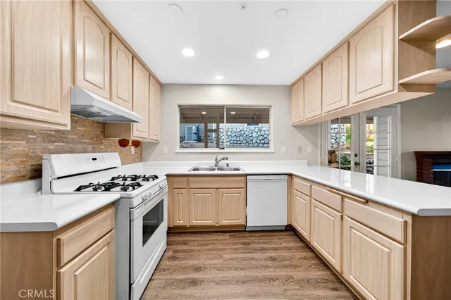 a kitchen with stainless steel appliances granite countertop a stove and a sink