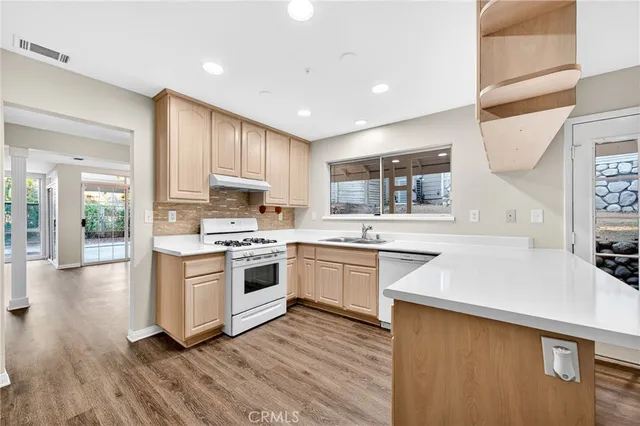 a kitchen with a sink stove and cabinets