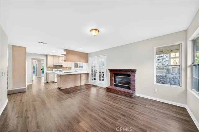 a view of kitchen with microwave and wooden floor