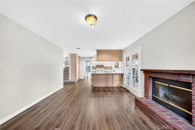 a kitchen with wooden floors and a fireplace