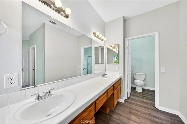 a bathroom with a double vanity sink and a mirror