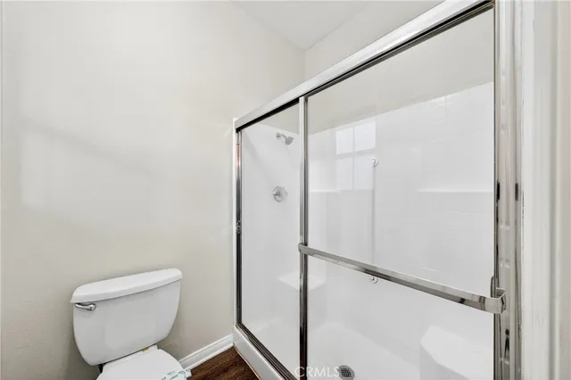 a bathroom with a toilet and a shower