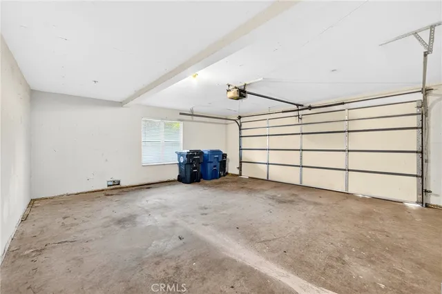 a view of a house with a yard and potted plants