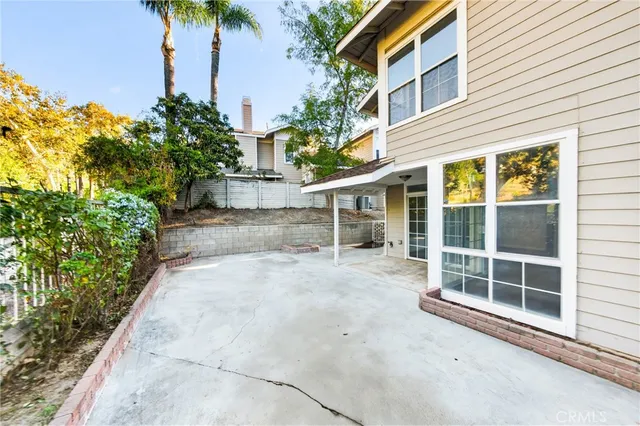a view of a house with a yard and potted plants