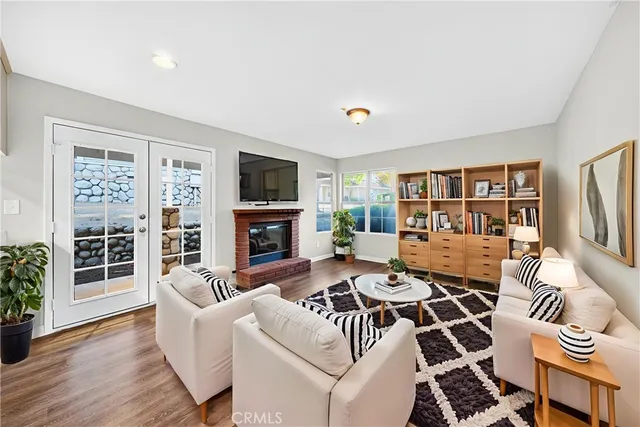a living room with furniture a flat screen tv and a fireplace