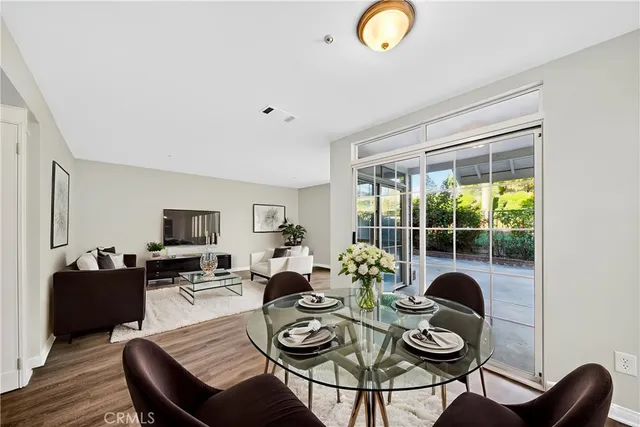 a living room with furniture and a floor to ceiling window