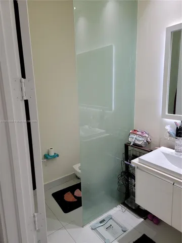 a bathroom with a sink toilet and a mirror