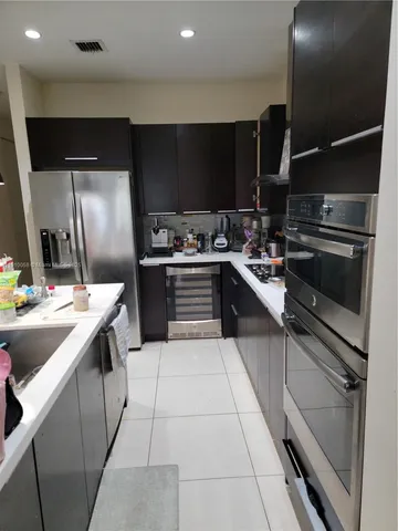 a kitchen with a sink stainless steel appliances and cabinets