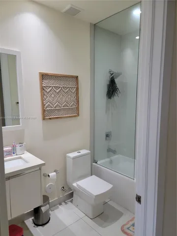 a bathroom with a toilet a sink and bathtub