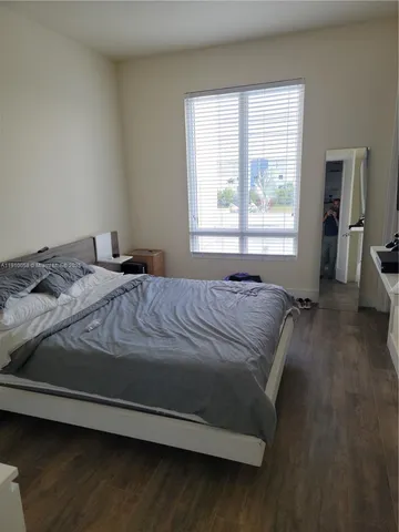 a bed sitting in a bedroom next to a window