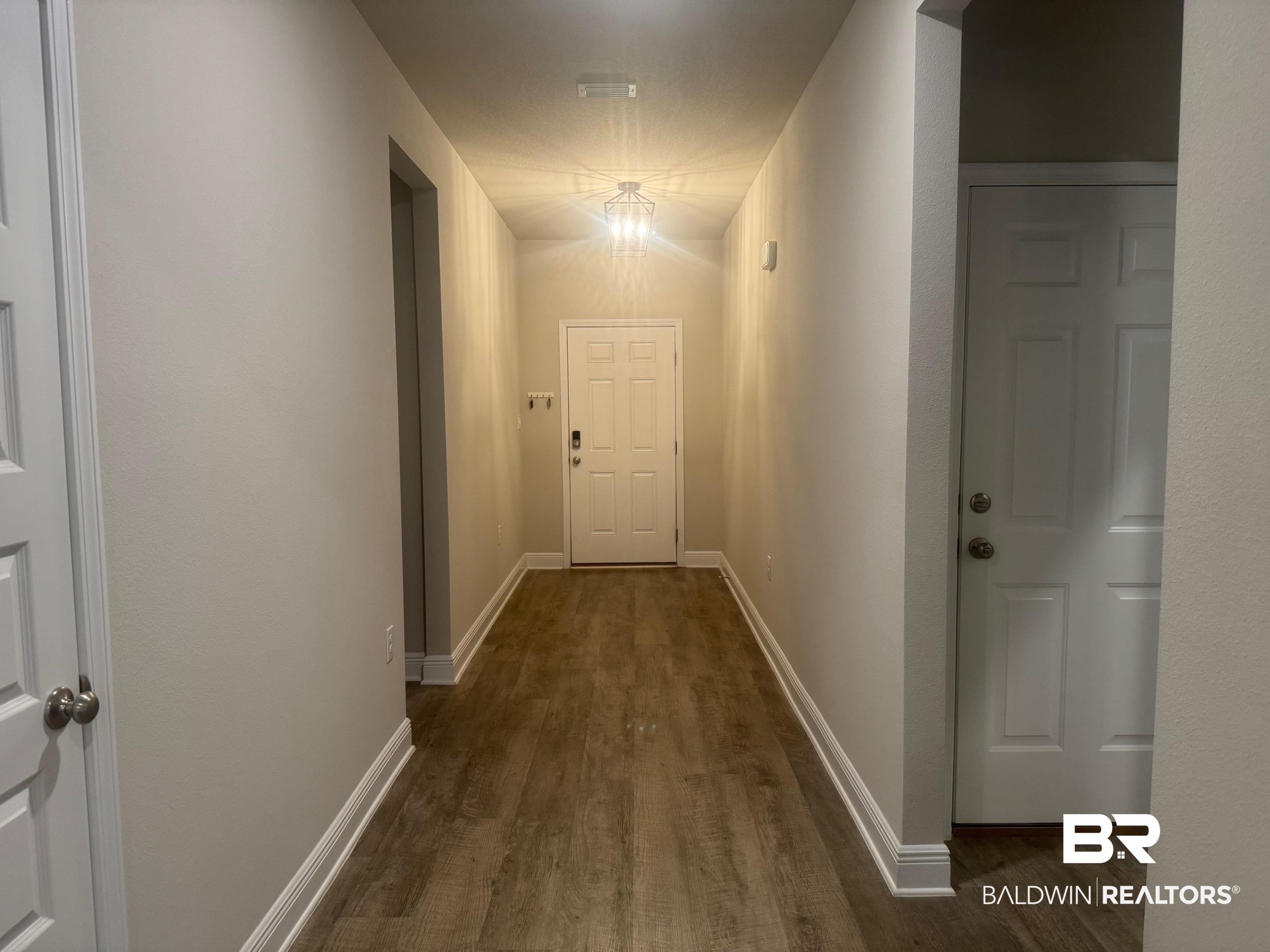24903 Spectacular Bid Loop Daphne, AL 36526 - Photo 30 of 37 Corridor with wood finished floors and baseboards