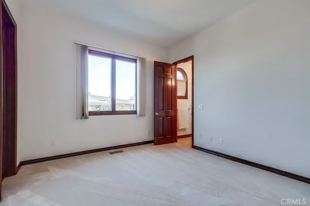 a view of a balcony with floor to ceiling windows with wooden fence