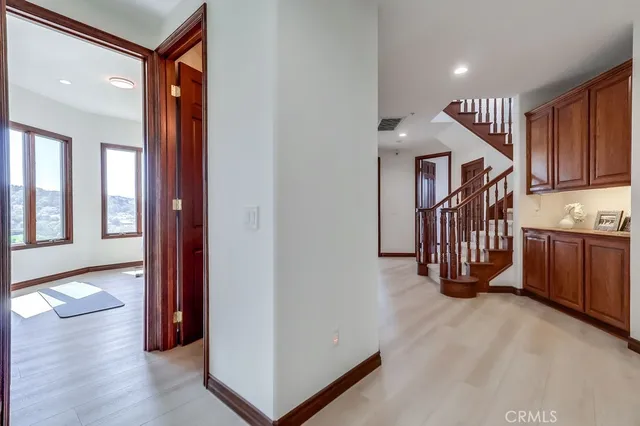 a view of staircase with railing and white walls