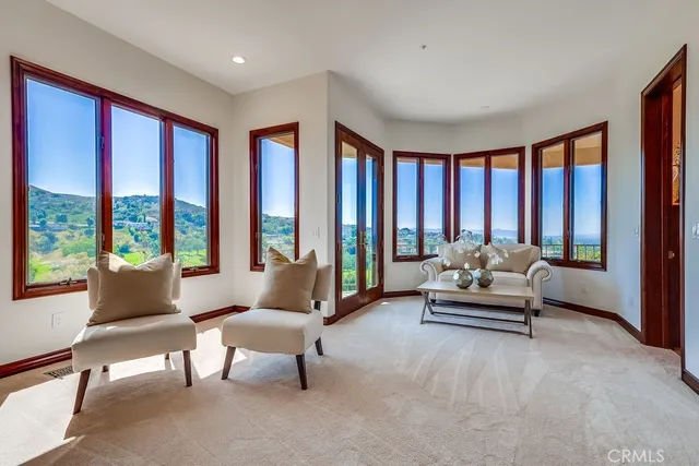 a view of a patio with table and chairs under an umbrella