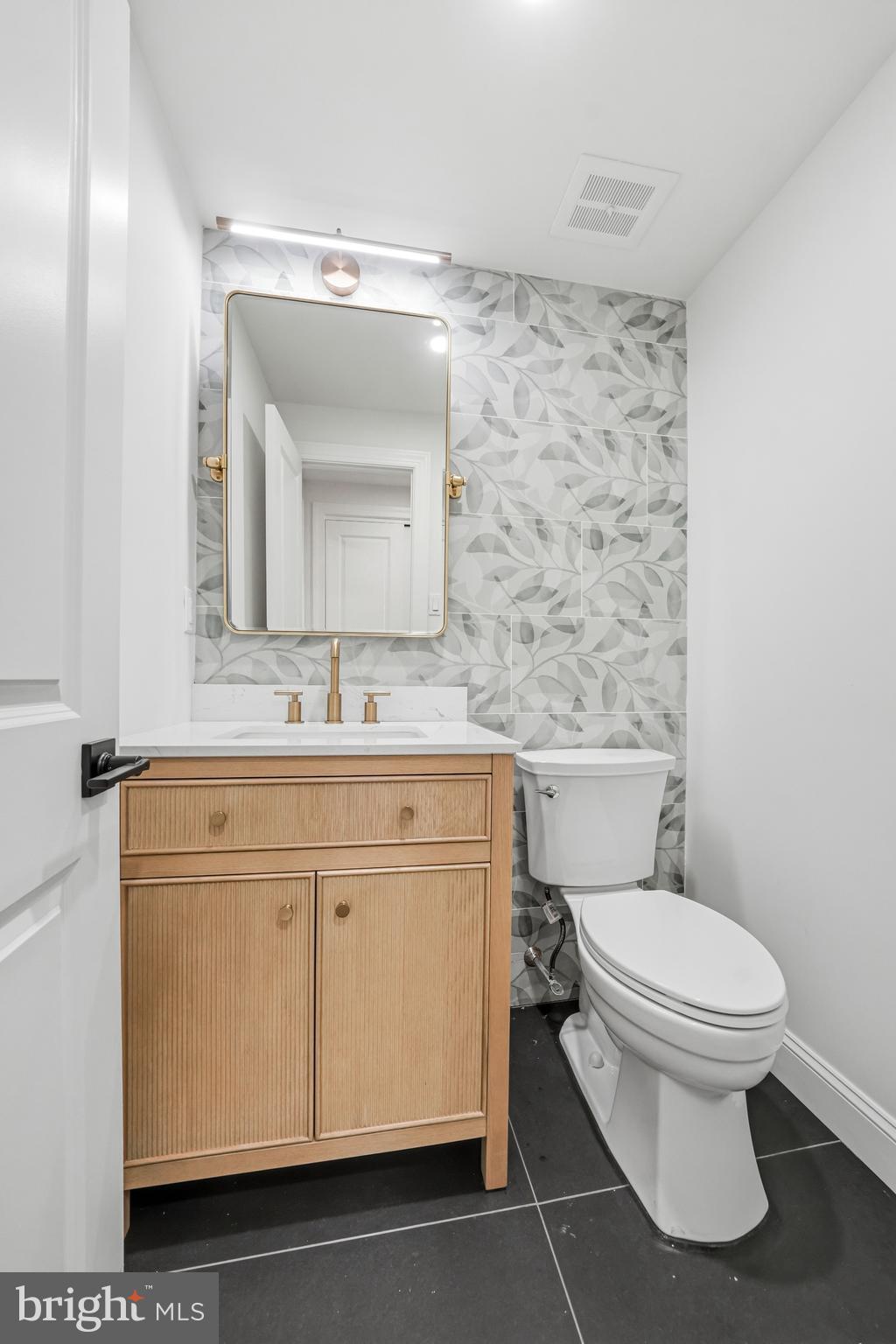 1309 Marlkress Road Cherry Hill, NJ 08003 - Photo 12 of 57 a bathroom with a granite countertop toilet sink and mirror