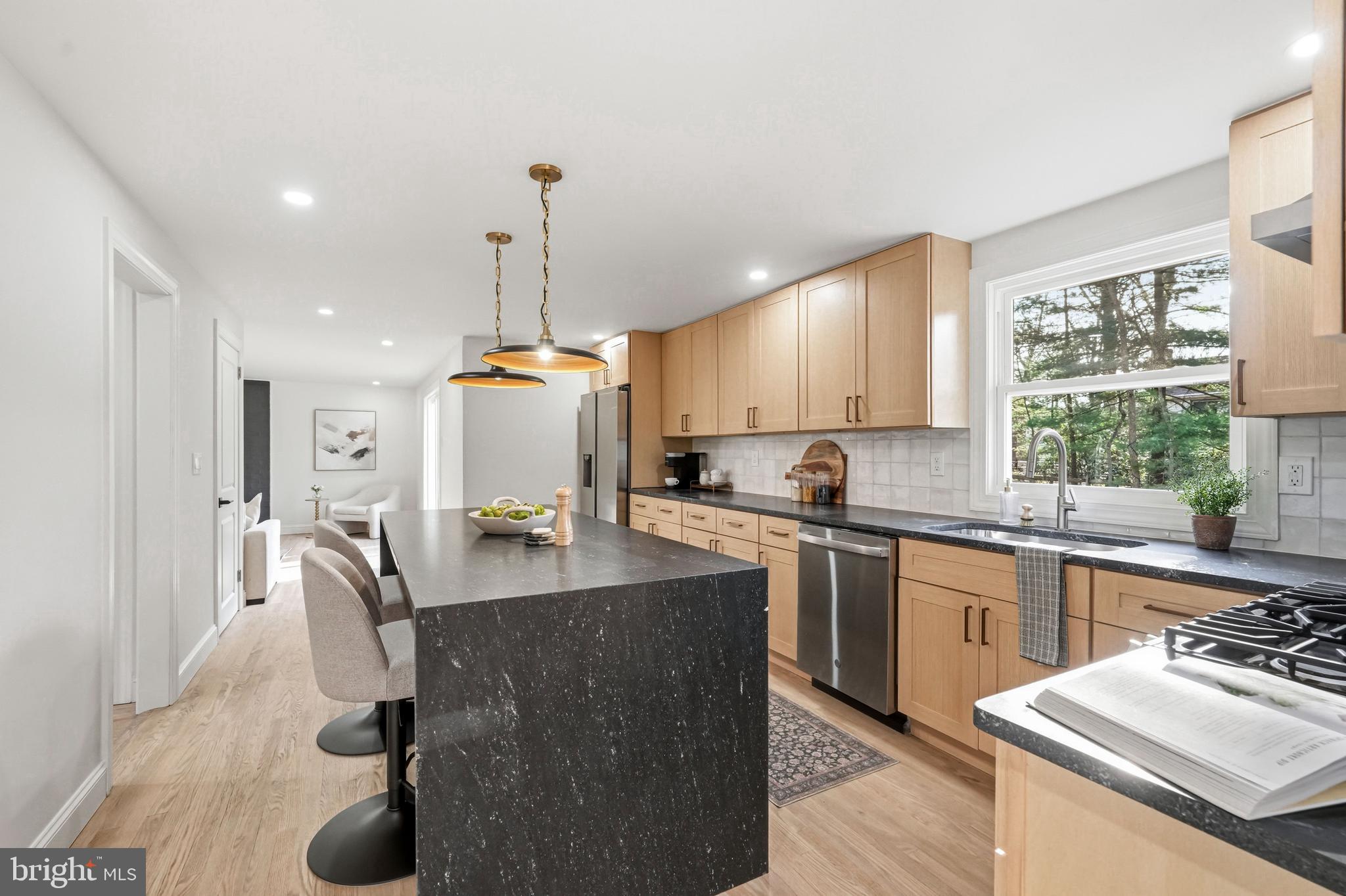 1309 Marlkress Road Cherry Hill, NJ 08003 - Photo 16 of 57 a kitchen with stainless steel appliances granite countertop a sink dishwasher a stove a refrigerator a dining table and chairs with wooden floor