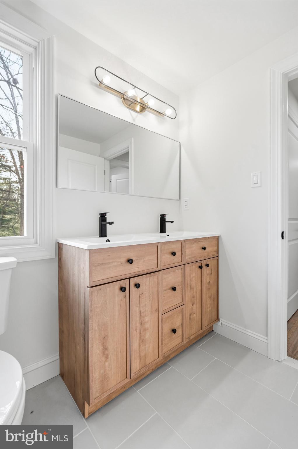 1309 Marlkress Road Cherry Hill, NJ 08003 - Photo 37 of 57 a spacious bathroom with a double vanity sink and a mirror