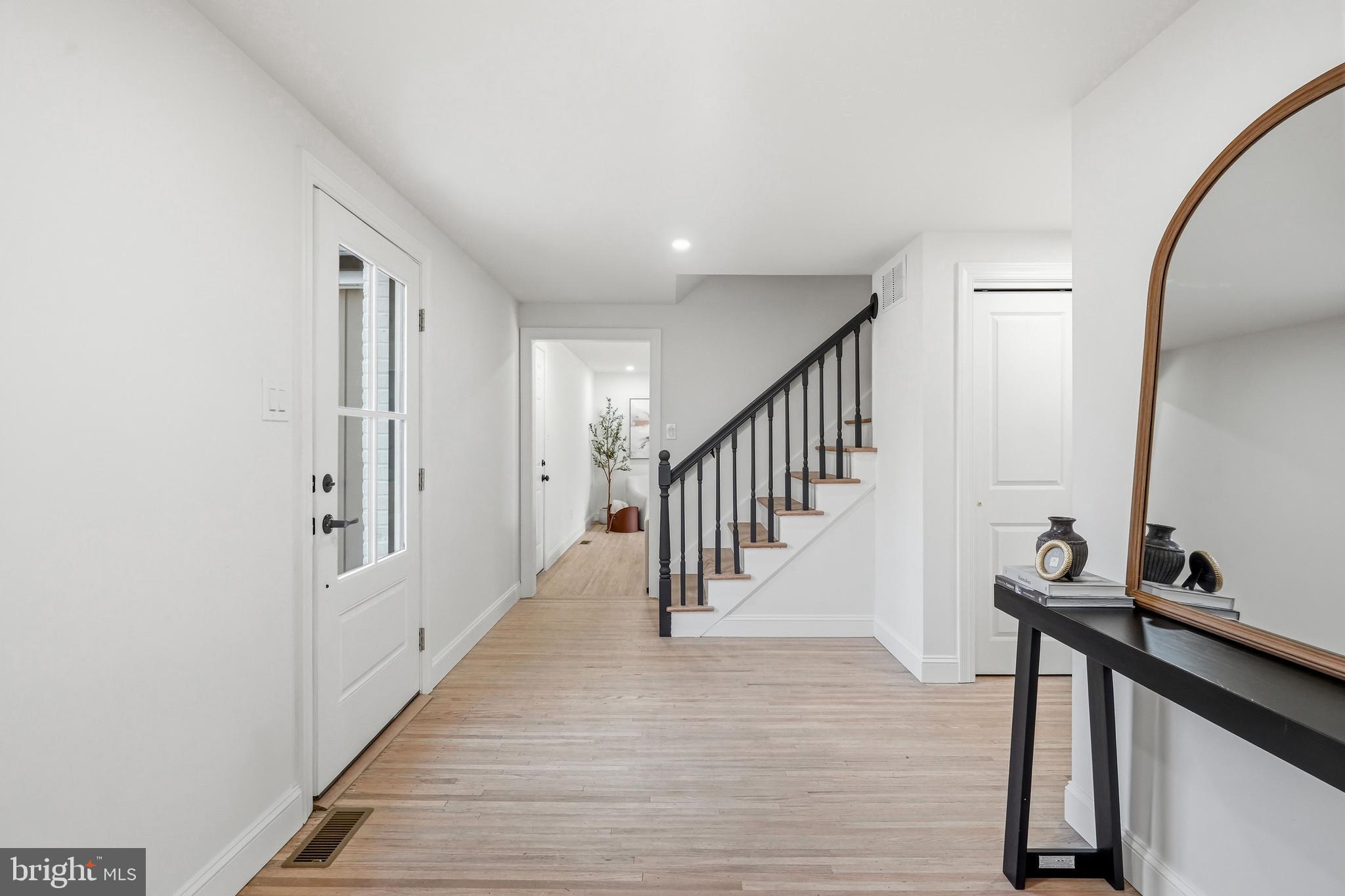 1309 Marlkress Road Cherry Hill, NJ 08003 - Photo 4 of 57 a view of a hallway with wooden floor and staircase