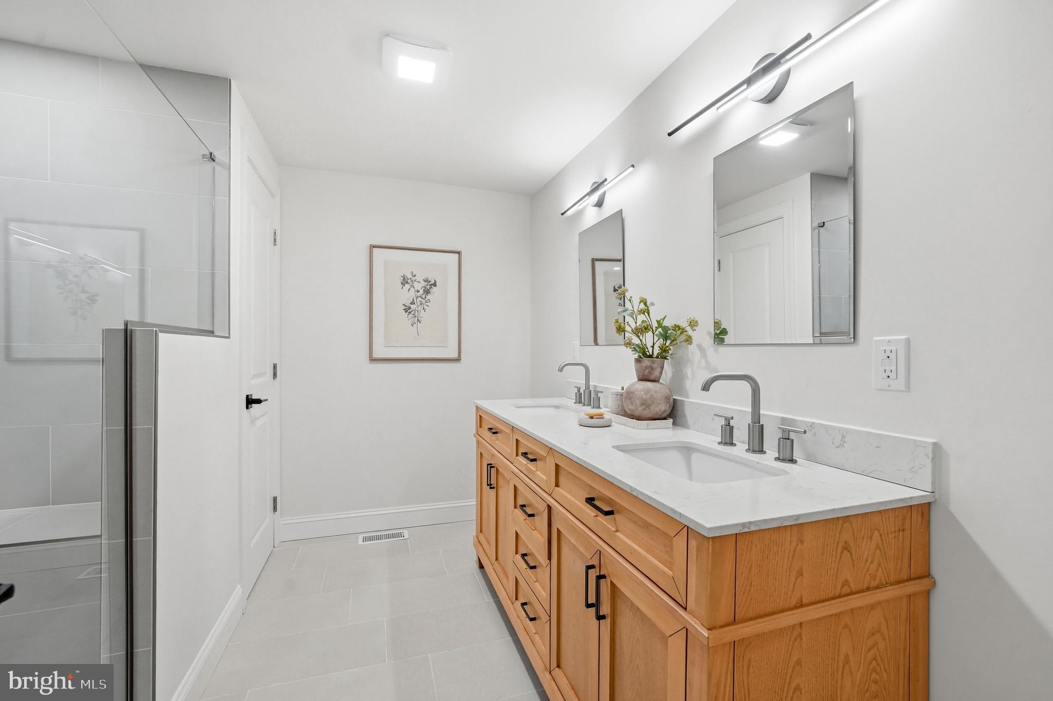 1309 Marlkress Road Cherry Hill, NJ 08003 - Photo 42 of 57 a bathroom with a double vanity sink and a mirror