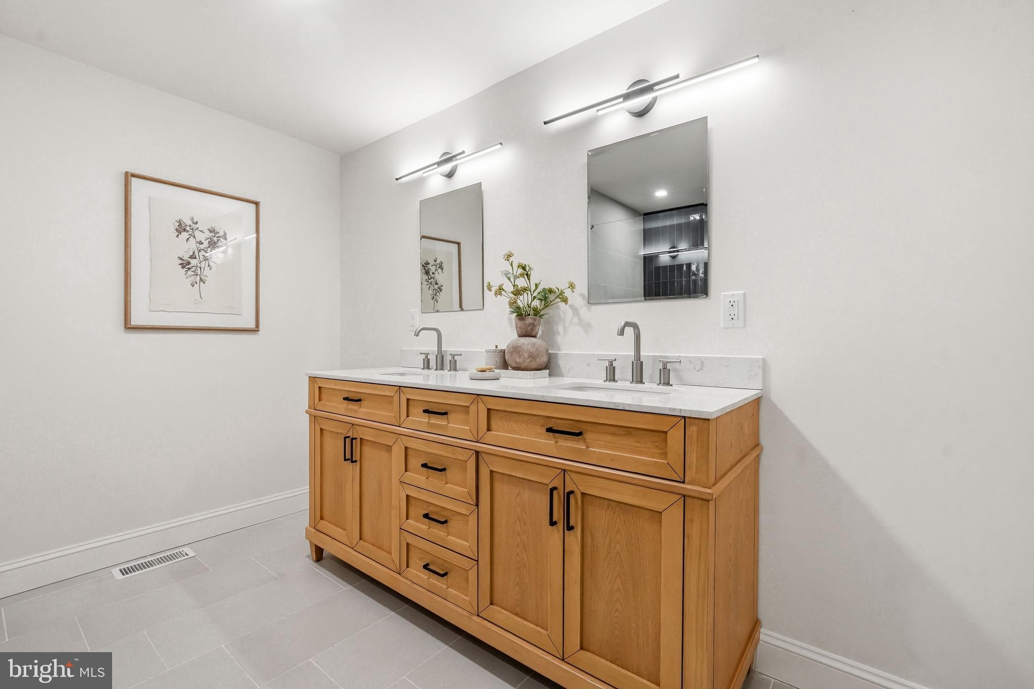 1309 Marlkress Road Cherry Hill, NJ 08003 - Photo 47 of 57 a bathroom with a double vanity sink and a mirror