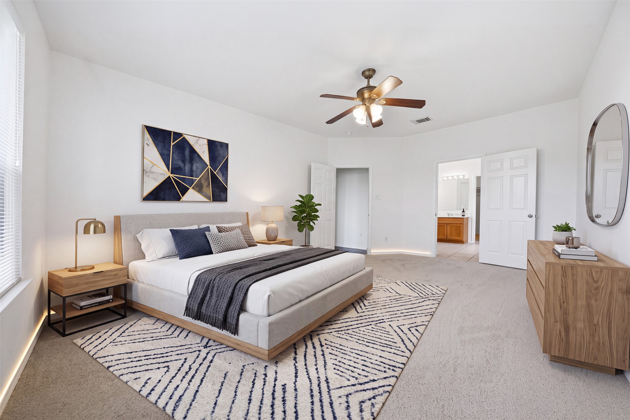 118 Invierno Street Kyle, TX 78640 - Photo 23 of 37 A spacious primary bedroom features soft carpeting, a ceiling fan, and abundant natural light.